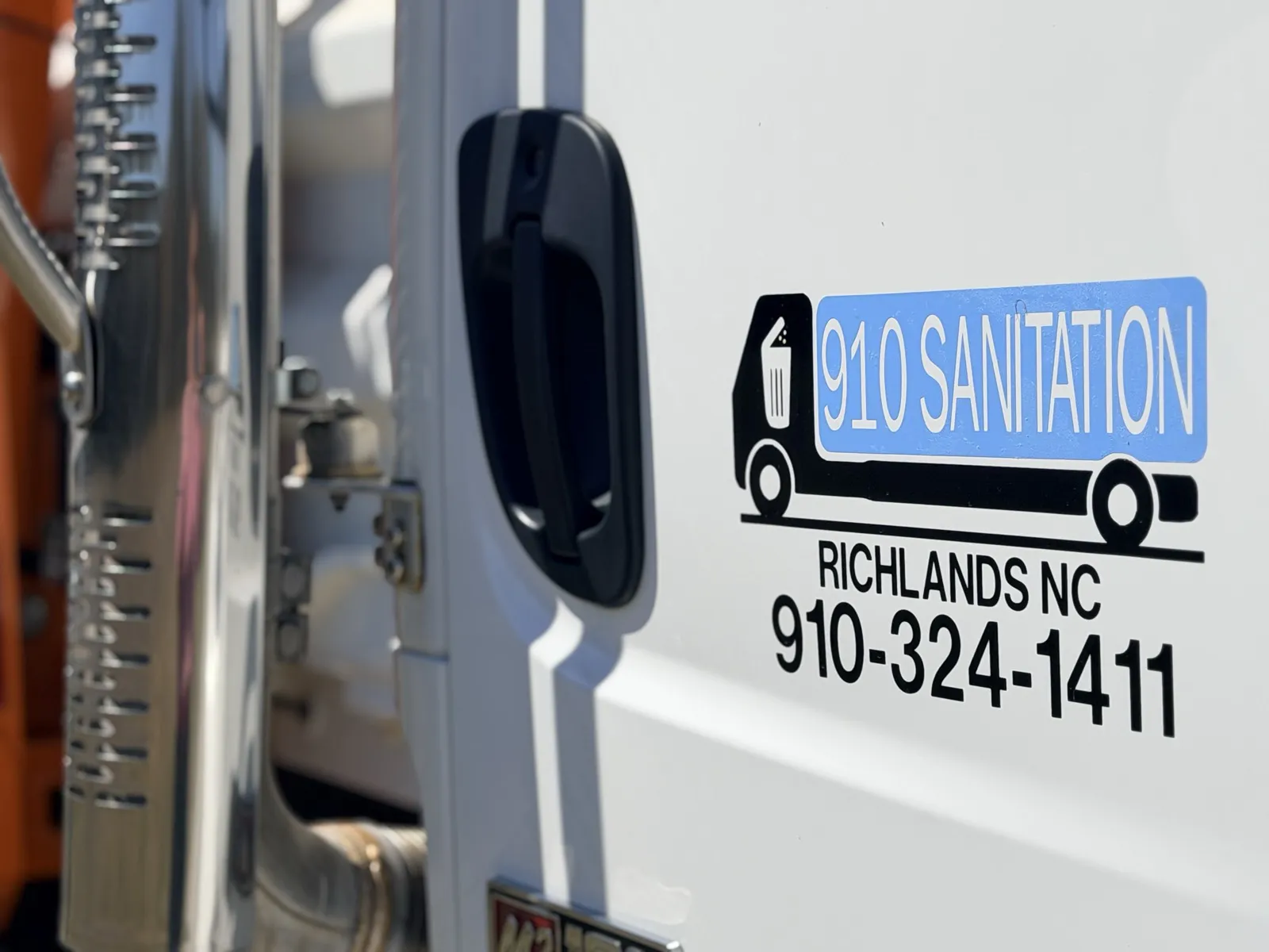 910 Sanitation logo on truck with Richlands NC phone number